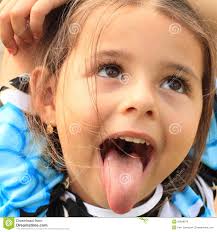 Funny face of a little girl in black-blue-white t-shirt with tongue out from the mouth. By Petr Zamecnik. MR: YES; PR: NO - funny-face-little-girl-black-blue-white-t-shirt-tongue-out-mouth-32848070