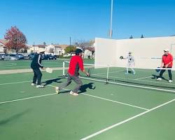 Image of people playing pickleball in a park
