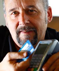 PAY OPTION: Electronic point of sales company Eftco owner Alex Castle holds a payWave card. - 9605832