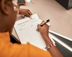Image of person signing a will