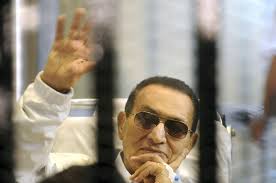 Former Egyptian President Hosni Mubarak waves to his supporters from behind bars as he attends a - APTOPIX-Mideast-Egypt_Horo1