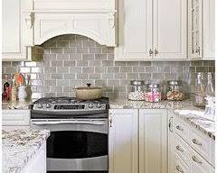 تصویر kitchen with cream cabinets and a gray backsplash