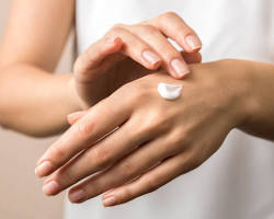 Obraz: closeup of hand with cream being applied