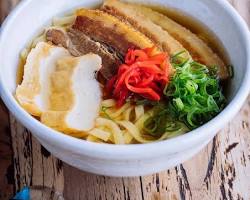 bowl of traditional Okinawa Soba with various toppingsの画像