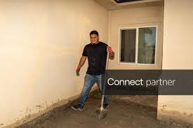 Licensable picture: Rafael Leon stands where water entered parts of his parents home from remnants of Tropical Storm Rachel on Harbor Drive in North