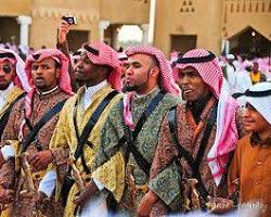 صورة people dancing in traditional Saudi clothing at the East Coast Festival