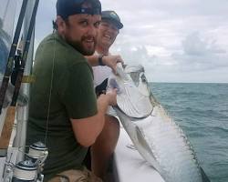 Image of angler holding a massive tarpon in Tampa Bay