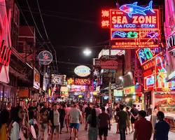 Image of Pattaya Walking Street at night, with neon lights and crowds