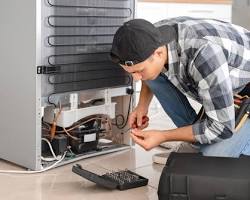 Hình ảnh về technician repairing a refrigerator