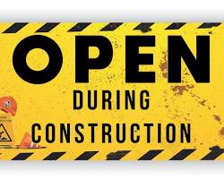 Image of construction site with a banner or sign that says Tender Notice or Bidding Open