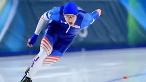 Speed skater rounding a corner with intensity
