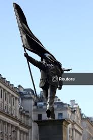 Licensable picture: A statue depicting a person stepping off the plinth while carrying a flag covering their face, by British street artist Banksy, stands in London