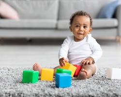 Image of Baby playing with block