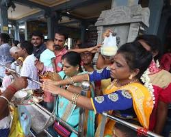 Image of devotees offering prayers at Murugan temple