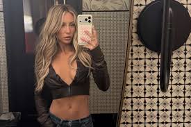 Alix Earle Attends Super Bowl 2026 in a Plunging Crop Top and Low-Rise Denim