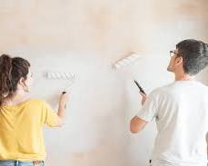 Image of stressed homeowner juggling paint cans and tools