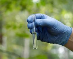 Image of Environmental health, graphic with a person testing water quality