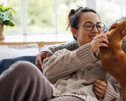 Image of House sitter giving love and attention to pets