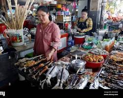 Image of Street food vendor in Cambodia selling grilled meats and noodles