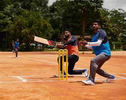 Image of cricket player hitting a tennis ball with a cricket bat