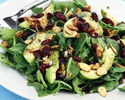 plate with a variety of leafy greens and nuts 이미지