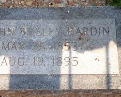 Image of weathered tombstone in a cemetery, bearing the name John Wesley Hardin