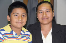 CARRIE MILLER PHOTO | Lorenza Leal, 28, and her son, Juan Basurto, 7, at the North Fork Spanish Apostolate in Riverhead last month where she volunteers. - R0808_mixteco_CM_C