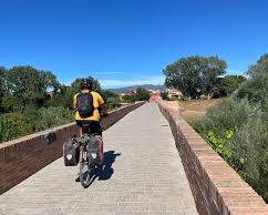 cyclists riding along canal trees Empuriabrava blue sky, généré par IA