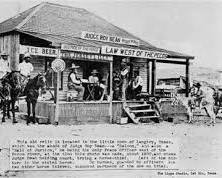 Image of saloon in Abilene, Kansas, in the early 1870s, filled with cowboys, gamblers, and dance hall girls