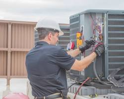 Image of Angels Heating and Cooling technicians installing an AC unit