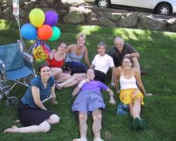 person surrounded by family and friends