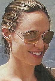 The lens itself isn&#39;t made of gold, obviously, but its flash comes from a 24k gold coating that creates an amazing gold mirror that can&#39;t be found on any ... - Angelina-Jolie-Perry-Gold-Sunglasses