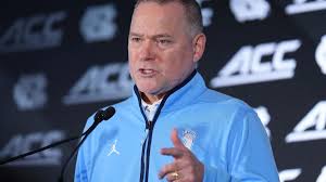 UNC basketball coach Michael Malone speaks at ACC Tipoff 2026 with Tar Heels roster behind him