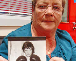 Londonderry, Northern Ireland: Kay Duddy, 64, always carries a photo of her brother Jackie Duddy, who at age 17 was shot and killed by British paratroopers, ... - nw-nireland-bloo_702341gm-a