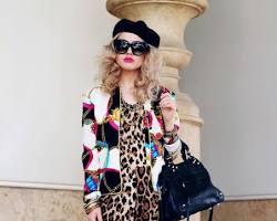 Image of woman wearing a 70s animal print jumpsuit with different hat styles