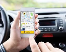 Image of person holding a taxi app