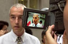 Swiss Falun Gong practitioner Erich Bachmann, 40, from the village of Kreuzlingen is seen through a reporter&#39;s video camera viewfinder as he talks to the ... - 2002-6-18-_hk103