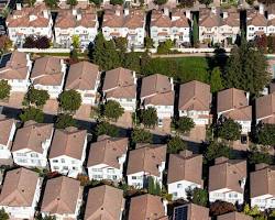 Sprawling suburban development with identical houses and yards