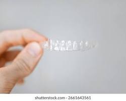 Image of clear dental aligners in hand