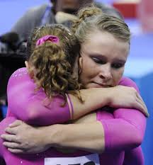 Gold medallist US gymnast Bridget Sloan hugs silver medallist US.