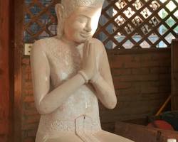 Cambodian artisan carefully engraving an intricate design onto a piece of metal.