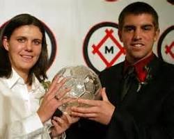 Christine Sinclair holding a soccer trophy