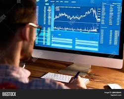 Image of person looking at a cryptocurrency chart on a computer screen
