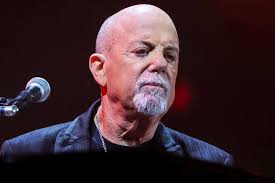 Billy Joel performs live on stage, showcasing his musical talent and charisma
