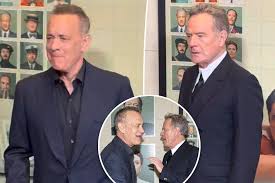 Tom Hanks and Bryan Cranston Joke Around with Photographers at 'The Phoenician Scheme' Premiere