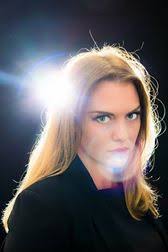 head and shoulders portrait of Zoe Clews, Hypnotist, with black background and heavy lens ... - zoe-flare