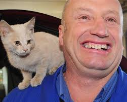 Mike Teasdale, of Mike Teasdale Motors, Dunedin, with the stray kitten which hitched a ride to the garage in a car engine bay yesterday morning. - mike_teasdale_of_mike_teasdale_motors_dunedin_with_2072166964