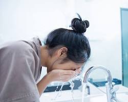 Image of woman washing face