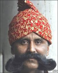 Lalan Singh, 40, a doorman for the Legend of India restaurant, poses with. Many young urban people see facial hairs as &quot;so last century&quot; - _45337566_006635466-1