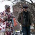 Griffin Dunne stands smiling on a film set